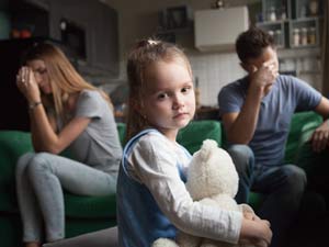 Frustrated girl tired of parents fights, child and divorce concept